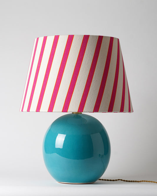 Turquoise round ceramic lamp with striped  lampshade.